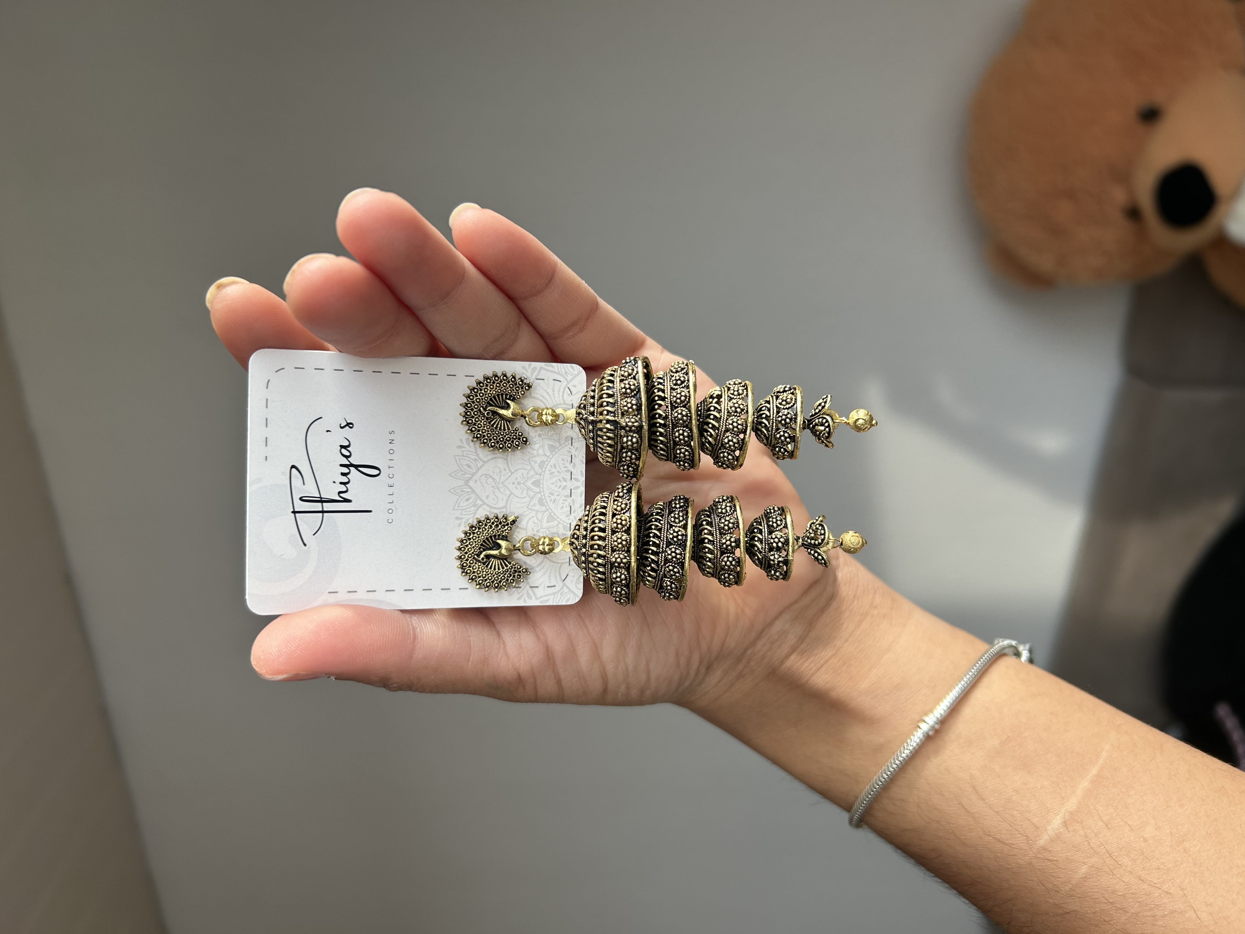 Thiya's Peacock Antique Jhumkas mit detailliertem Pfau-Stud-Design und antikem Finish ideal für Funktionen Hochzeiten und festliche Trachten